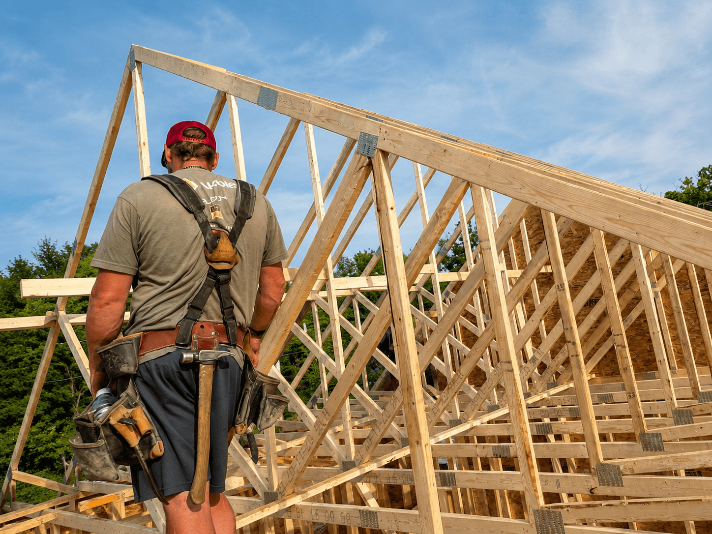 Builder looking across framed roof structure